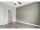 Bedroom with access to ensuite bathroom, ceiling fan, and wood-look floors at 10 Grace Bay Ct., Pawleys Island, SC 29585