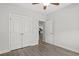 Bright bedroom features a ceiling fan, wood-look flooring, and access to other rooms at 10 Grace Bay Ct., Pawleys Island, SC 29585