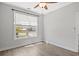 Bright bedroom with hardwood floors and a large window offering peaceful views at 10 Grace Bay Ct., Pawleys Island, SC 29585