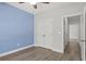 A serene bedroom featuring a blue accent wall, wood-look flooring, and a spacious closet at 10 Grace Bay Ct., Pawleys Island, SC 29585