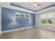 Spacious bedroom featuring a trey ceiling, four windows and modern light fixtures at 10 Grace Bay Ct., Pawleys Island, SC 29585