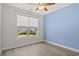 Bedroom with hardwood floors, natural light, and a neutral blue accent wall at 10 Grace Bay Ct., Pawleys Island, SC 29585