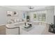 Stylishly furnished living room with hardwood floors, modern ceiling fan, and sliding glass doors at 10 Grace Bay Ct., Pawleys Island, SC 29585