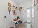 Inviting mudroom boasts seating with storage, decor, and an open doorway at 10 Grace Bay Ct., Pawleys Island, SC 29585