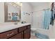 Full bathroom with dark wood cabinets, neutral walls, and a blue shower curtain at 113 Preservation Dr., Myrtle Beach, SC 29572