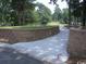 Entrance to community featuring stone retaining walls and green space at 113 Preservation Dr., Myrtle Beach, SC 29572
