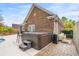 Backyard with brick and concrete patio featuring a hot tub and outdoor furniture at 113 Preservation Dr., Myrtle Beach, SC 29572