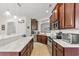 Elegant kitchen with a breakfast bar, stainless steel appliances, dark wood cabinets, and marble countertops at 113 Preservation Dr., Myrtle Beach, SC 29572