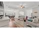 Open-concept living room featuring hardwood floors, a tray ceiling, and ample seating, ideal for entertaining guests at 113 Preservation Dr., Myrtle Beach, SC 29572