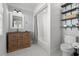 Bathroom with a shower/tub combo, a pedestal sink, and open shelving at 1187 Norris Dr., Pawleys Island, SC 29585