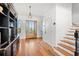 Bright entryway with hardwood floors, built-in shelving, and staircase at 1187 Norris Dr., Pawleys Island, SC 29585