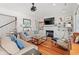 Living room with fireplace, built-in shelves, and hardwood floors at 1187 Norris Dr., Pawleys Island, SC 29585