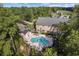 Scenic aerial view of a community pool, surrounded by lush greenery, a building, and a parking area at 141 Foxford Dr., Conway, SC 29526