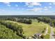 Breathtaking aerial shot of a golf course surrounded by verdant trees and blue sky, showcasing the beautiful landscape at 141 Foxford Dr., Conway, SC 29526
