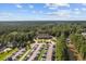 Breathtaking aerial view of a grand building with a parking lot nestled among a lush forest, and a serene lake at 141 Foxford Dr., Conway, SC 29526