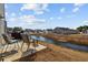 Backyard with a patio overlooking a pond and manicured lawns at 141 Foxford Dr., Conway, SC 29526