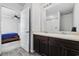 Well-lit bathroom with double sink vanity, a large mirror, and doorway access to another room at 141 Foxford Dr., Conway, SC 29526