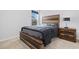 Stylish bedroom with a wood-framed bed, carpet flooring and a bedside table with a lamp at 141 Foxford Dr., Conway, SC 29526