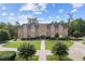 Stunning building with a castle-like stone facade, symmetrical windows, and pristine landscaping for a regal and inviting ambiance at 141 Foxford Dr., Conway, SC 29526