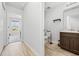 Hallway with doorway access to a well lit bathroom featuring a toilet and sink at 141 Foxford Dr., Conway, SC 29526