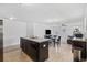 Well-lit kitchen with an island, dark cabinets, and modern appliances at 141 Foxford Dr., Conway, SC 29526