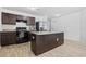 Modern kitchen with an island, dark wood cabinets, and stainless steel appliances at 141 Foxford Dr., Conway, SC 29526