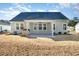 Home's backyard with covered patio, grass, and raised garden bed at 146 Caroline Ct., Murrells Inlet, SC 29576