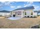 Home's backyard with covered patio, grass, and raised garden bed at 146 Caroline Ct., Murrells Inlet, SC 29576