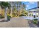 Home's backyard patio and landscaping with palm trees at 146 Caroline Ct., Murrells Inlet, SC 29576