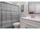 Simple bathroom with white vanity and shower curtain at 146 Caroline Ct., Murrells Inlet, SC 29576