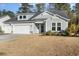 Two-story house with gray siding, three-car garage, and landscaped yard at 146 Caroline Ct., Murrells Inlet, SC 29576