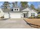 Two-story house with gray siding, three-car garage, and landscaped yard at 146 Caroline Ct., Murrells Inlet, SC 29576