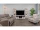 Relaxing living room featuring a large TV, comfortable seating, and wood-look floors at 146 Caroline Ct., Murrells Inlet, SC 29576