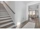 Modern staircase with wooden steps and neutral walls at 146 Caroline Ct., Murrells Inlet, SC 29576