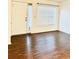 Bright living area with wood floors, a large window, and a white front door at 15 Century St. # 15, Myrtle Beach, SC 29577