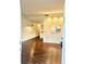 Open-concept living area with wood floors, stylish lighting, and a view into the kitchen at 15 Century St. # 15, Myrtle Beach, SC 29577