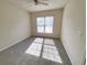 Bright bedroom with neutral walls and carpet, plus window at 155 E Chenoa Dr. # E, Murrells Inlet, SC 29576