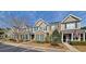 Two-story townhome with brick and siding exterior, landscaping, and American flag at 155 E Chenoa Dr. # E, Murrells Inlet, SC 29576