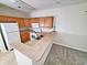 Galley kitchen with oak cabinets, white appliances, and neutral countertops at 155 E Chenoa Dr. # E, Murrells Inlet, SC 29576