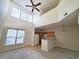 Open living room with high ceilings, kitchen bar, and neutral decor at 155 E Chenoa Dr. # E, Murrells Inlet, SC 29576