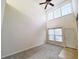 Open living room with high ceilings, neutral decor, and access to kitchen at 155 E Chenoa Dr. # E, Murrells Inlet, SC 29576