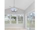 Sunroom with vaulted ceiling, chandelier, and sliding glass doors at 1727 Cane Branch Rd., Loris, SC 29569