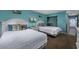 Guest bedroom with two twin beds and ocean themed decor at 202 75Th Ave. N # 5604/5605, Myrtle Beach, SC 29572