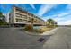Exterior view of a three-story building with parking and landscaping at 202 75Th Ave. N # 5604/5605, Myrtle Beach, SC 29572