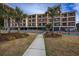 Oceanfront building, featuring a walkway, landscaping, and a pool at 202 75Th Ave. N # 5604/5605, Myrtle Beach, SC 29572