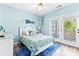 Bedroom with light blue walls, double doors to deck, and ocean decor at 204 24Th Ave. N, North Myrtle Beach, SC 29582