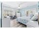 Bright bedroom with light blue walls, double doors to balcony, and a comfy bed at 204 24Th Ave. N, North Myrtle Beach, SC 29582
