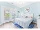 Bedroom with light blue walls, double doors to deck, and a queen bed at 204 24Th Ave. N, North Myrtle Beach, SC 29582