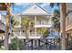 Two-story home with balconies, palm trees, and a fenced yard at 204 24Th Ave. N, North Myrtle Beach, SC 29582