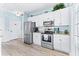 White kitchen with stainless steel appliances and granite counters at 204 24Th Ave. N, North Myrtle Beach, SC 29582